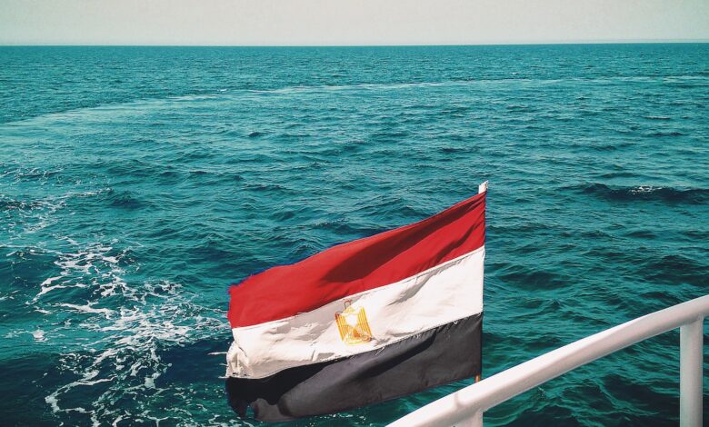 a flag on a boat in the middle of the ocean